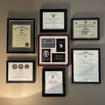 Arrangement of all dental awards hanging on wall